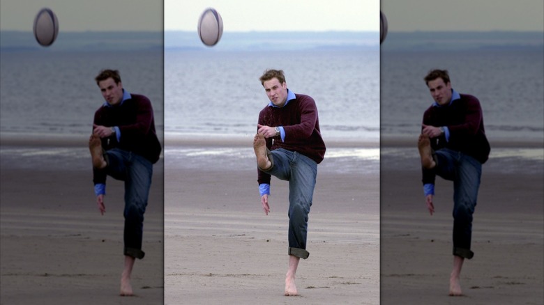 Prince William kicking a rugby ball at the beach