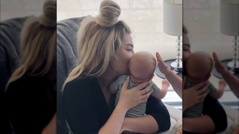 Erika Kirk holding her infant son