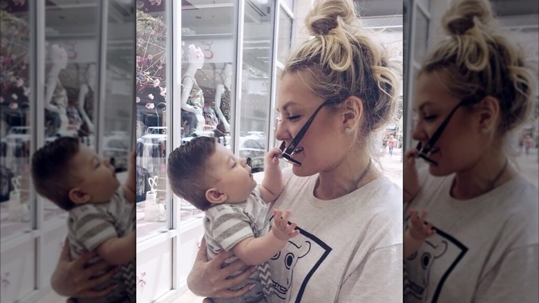 Erika Kirk glasses falling holding baby