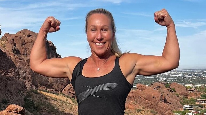 image of Marjorie Taylor Greene flexing her arms outdoors