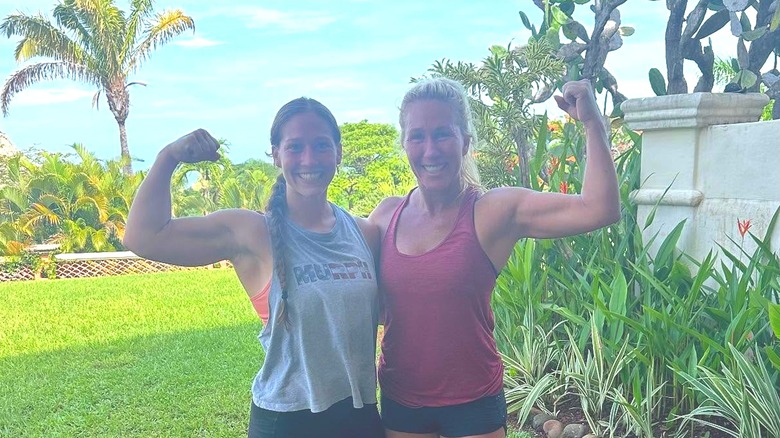 Marjorie Taylor Greene and her daughter hugging and flexing their arms