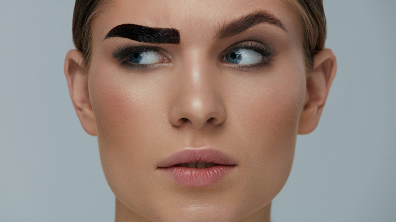 Woman with a single dyed brow