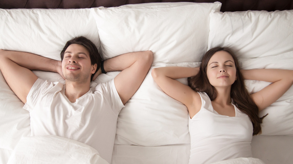 couple sleeping on generic mattress