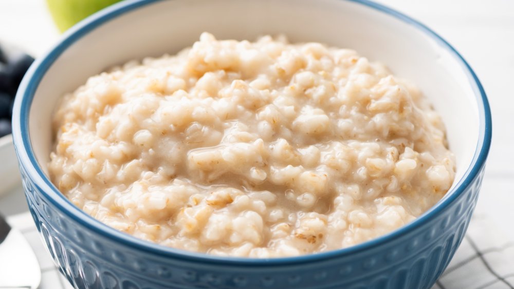 A blue bowl full of cooked oatmeal