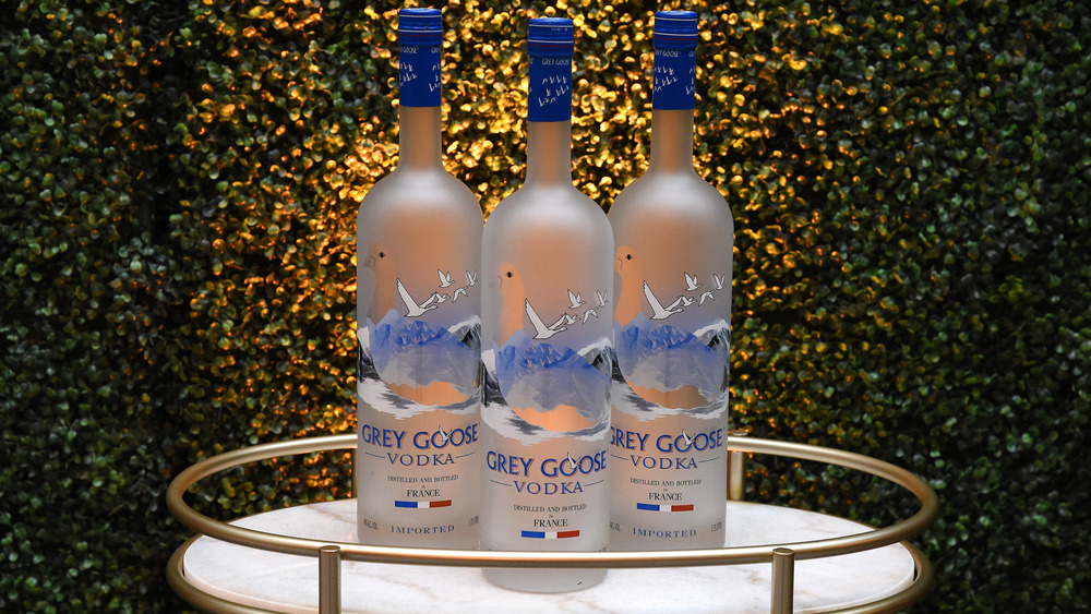 Three bottles of Grey Goose vodka on a tray