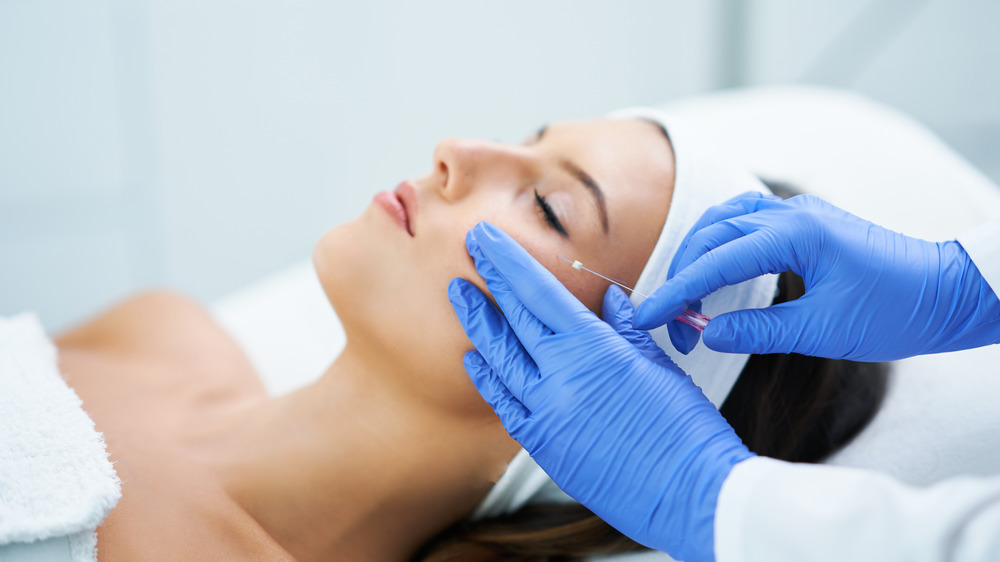 woman getting an injection in her face