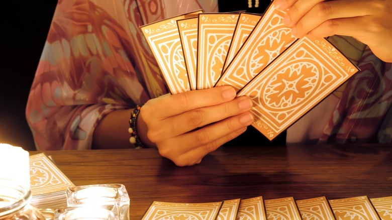 A tarot reader is preparing for a reading