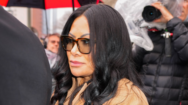 Jen Shah wearing sunglasses as paparazzi takes photo.