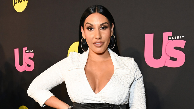 Monica Garcia wearing a white dress on the red carpet in October 2024.