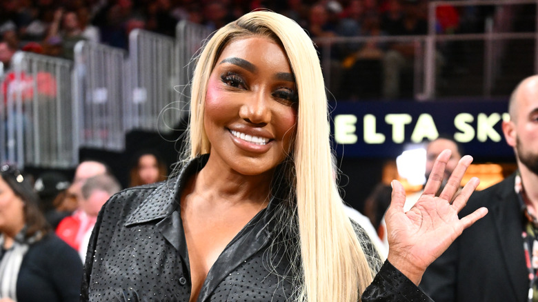 NeNe Leakes waving at the camera in her signature blonde hair in March 2026
