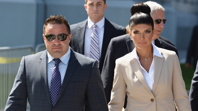 Teresa Giudice and Joe Giudice wearing suits and leaving court in August 2013.