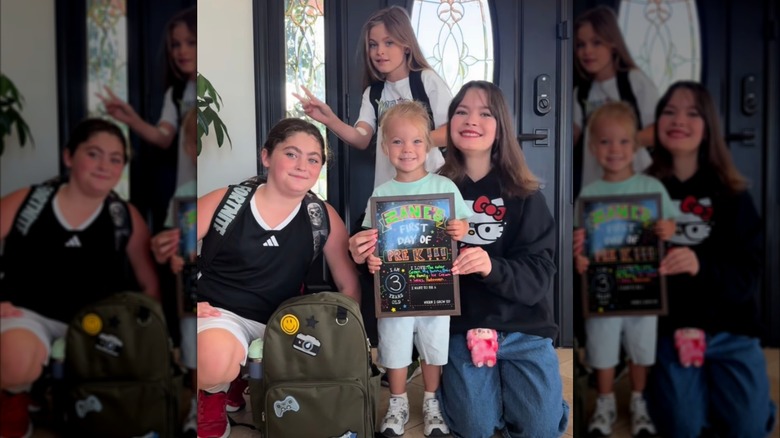 Three of Megan Fox's children smile with their half-brother by a door on the first day of school