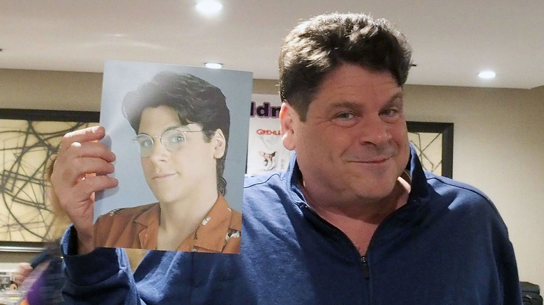 Marc Price posing with his headshot at an event