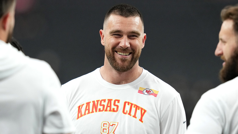 Travis Kelce smiling with other Kansas City Chiefs.