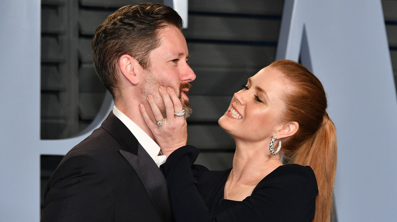 Amy Adams squishing Darren Le Gallo's cheeks.