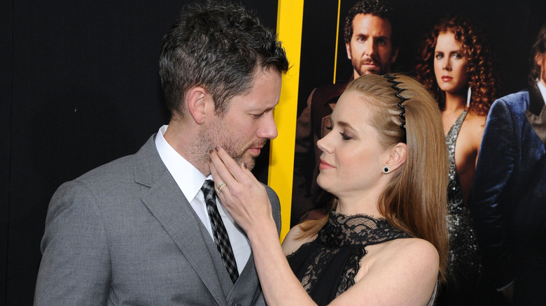 Amy Adams touching Darren Le Gallo's cheek.