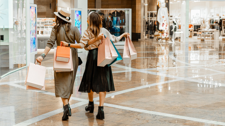 women in mall with shopping bags