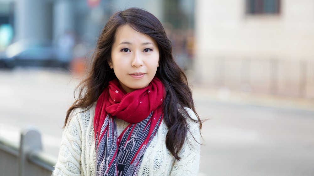 A woman wearing a red scarf