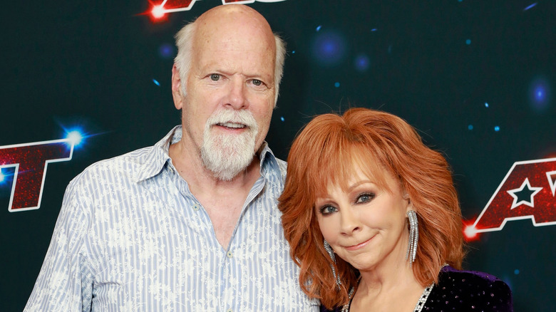 Rex Linn and Reba McEntire pose together at an event