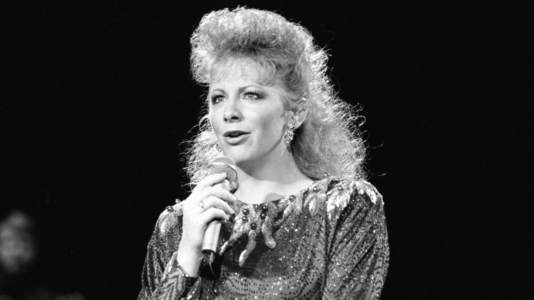 Reba McEntire singing into microphone