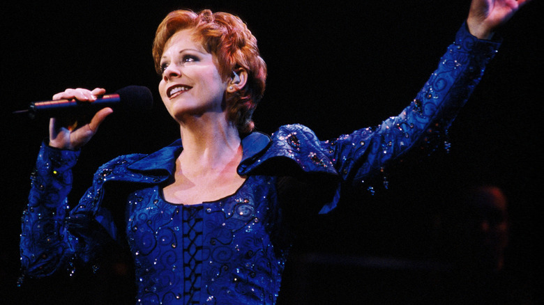 Reba McEntire singing into microphone