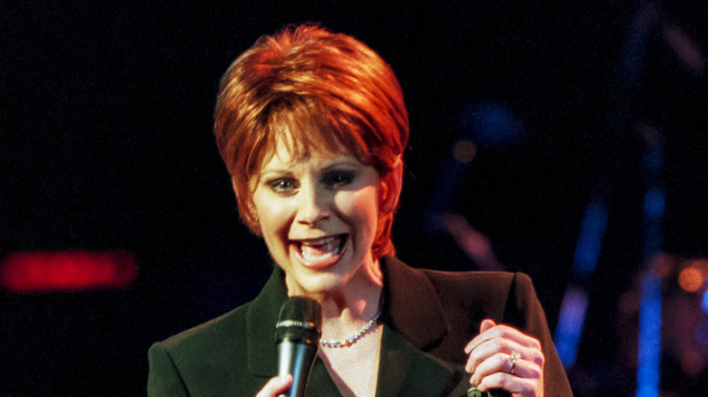 Reba McEntire singing into microphone