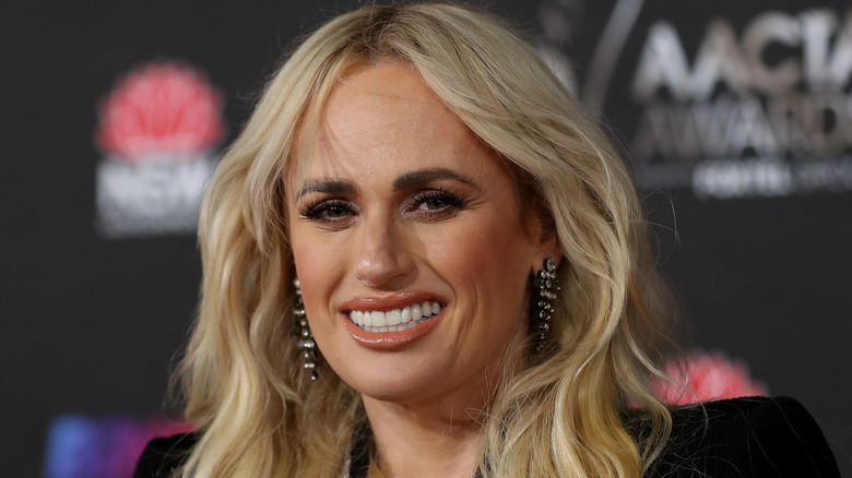Rebel Wilson smiling at an event in Sydney, showing a dramatically slimmer face