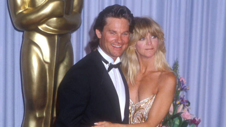 Kurt Russell smiling while Goldie Hawn looks concerned