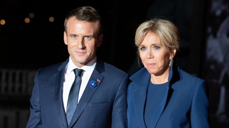 Emmanuel and Brigitte Macron posing for photos