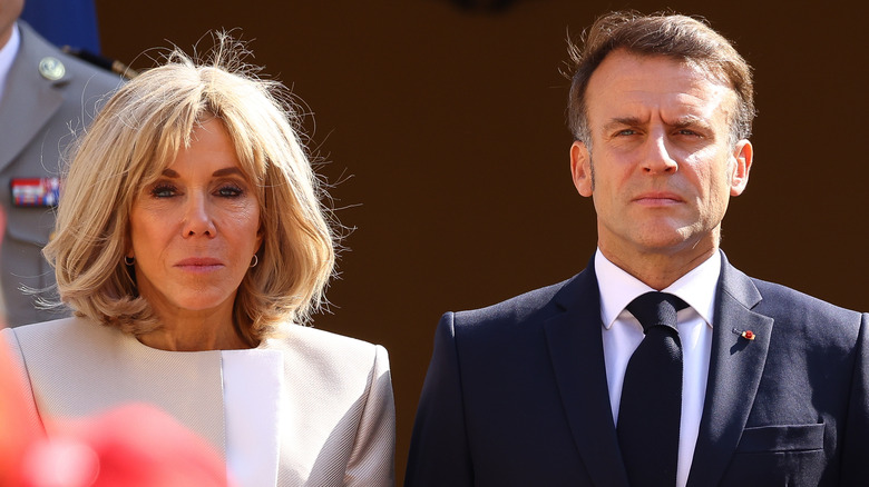 Brigitte and Emmanuel Macron looking grumpy