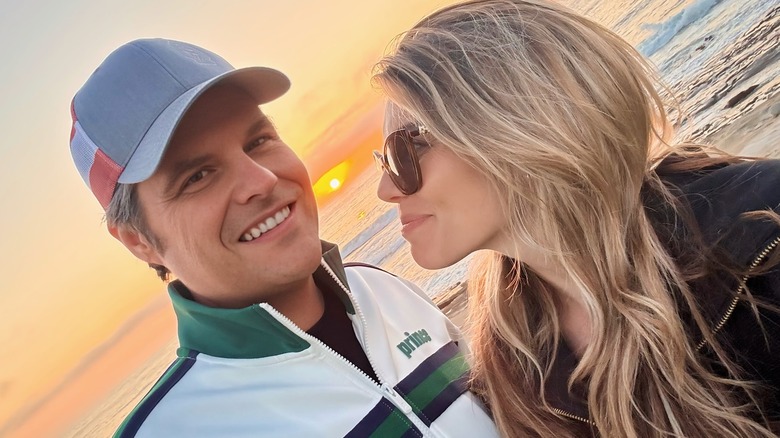 Ginger smiles at Matt Gaetz with a sunset in the background