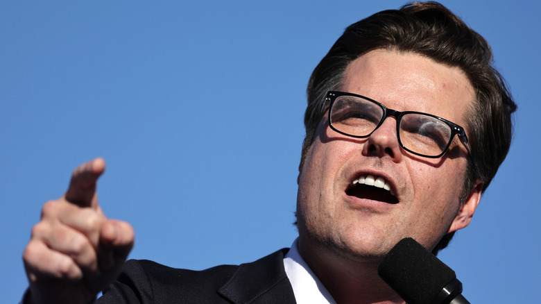 Matt Gaetz wearing glasses gives a speech at a campaign rally