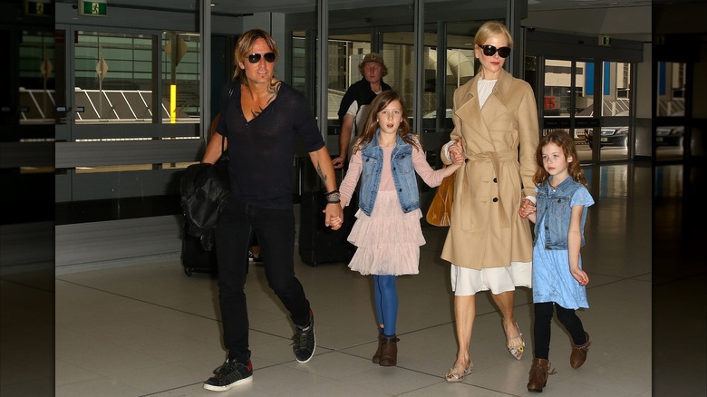 Keith Urban and Nicole Kidman walking with their daughters