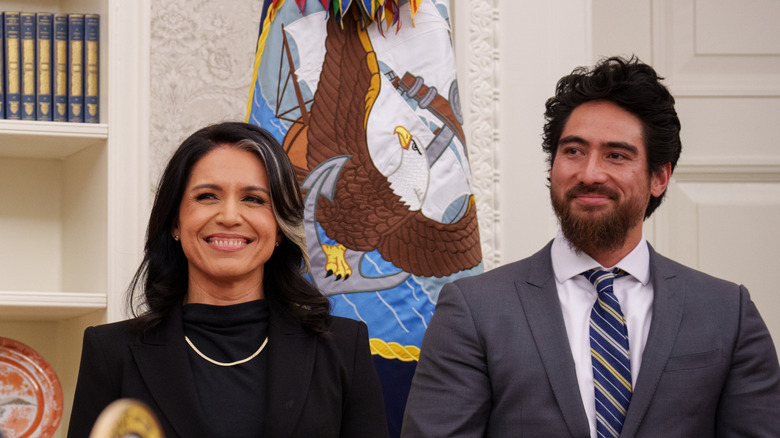 Tulsi Gabbard and Abraham Williams smiling and looking to the left