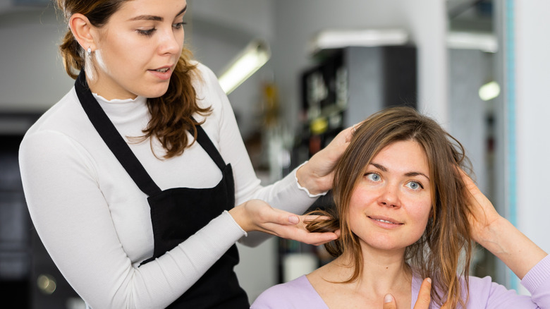 Hairdresser talking to client