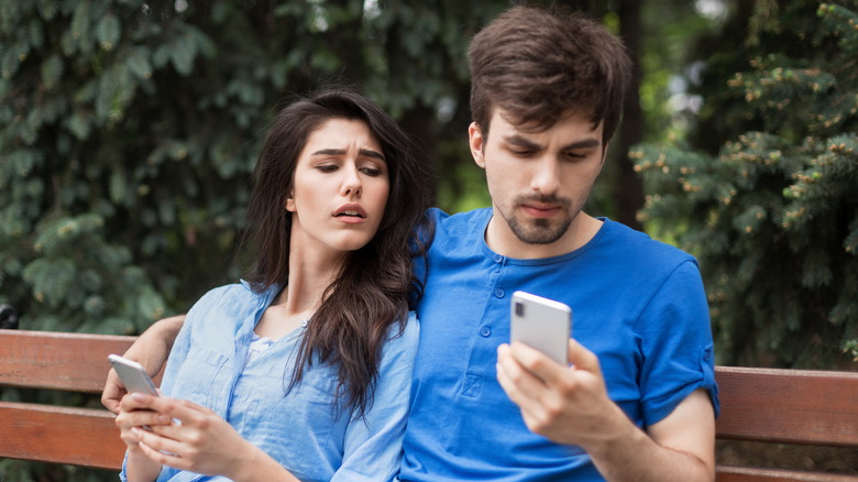 Woman suspicious over man's phone