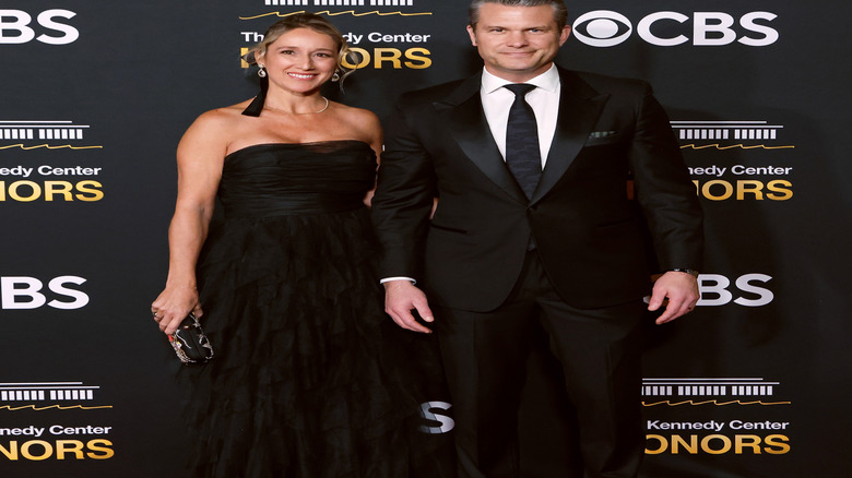 Pete Hegseth and Jennifer Rauchet smiling on the red carpet.
