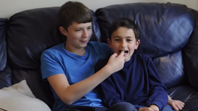Charlie Davies-Carr biting Harry Davies-Carr's finger ten years after their video
