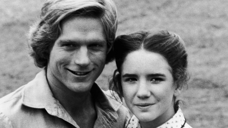 Dean Butler smiling while posing on the set of 