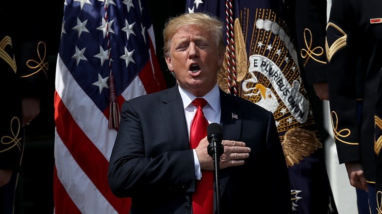 Donald Trump with his hand on his heart singing along to National Anthem (2018)