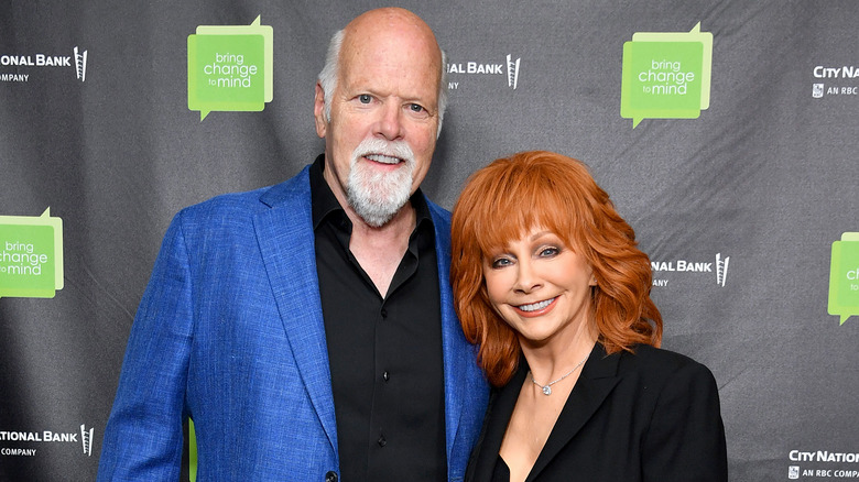 Rex Linn and Reba McEntire posing on the red carpet