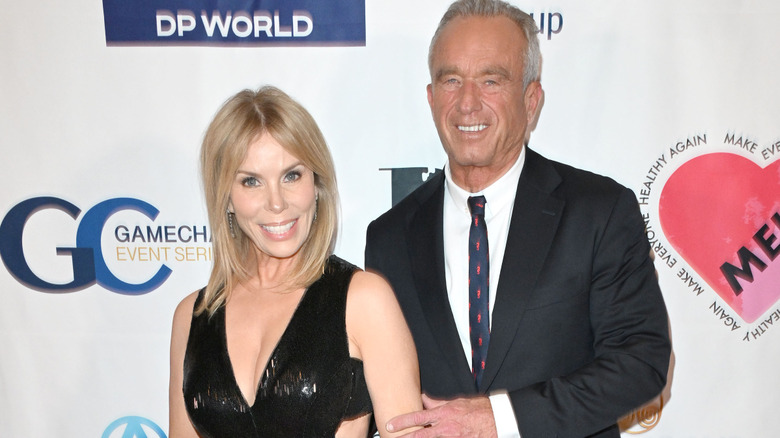 Cheryl Hines black dress with RFK Jr. holding her arm