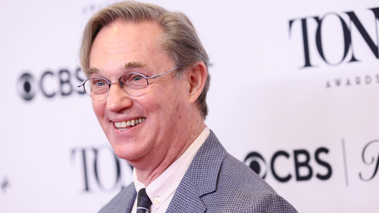 Richard Thomas smiling in a suit