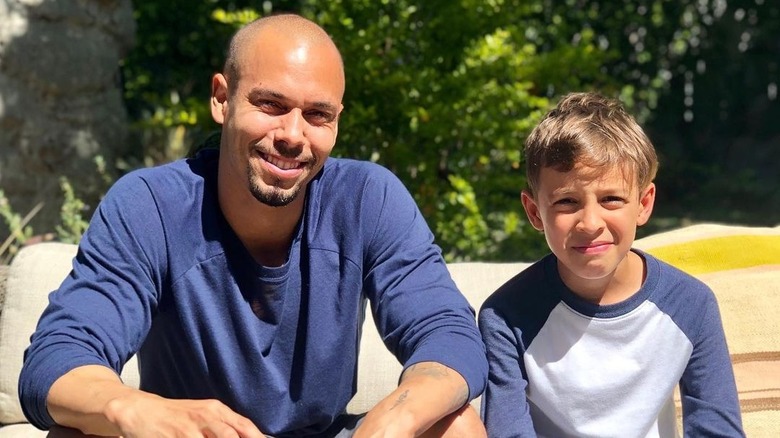 Bryton James smiling with godson