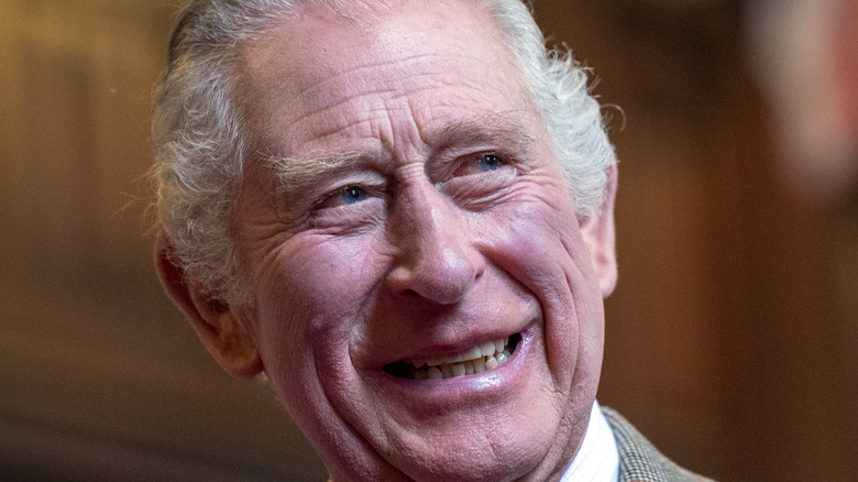 King Charles III smiles