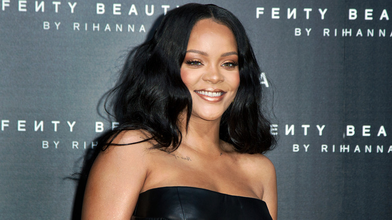Rihanna smiling with Fenty logo