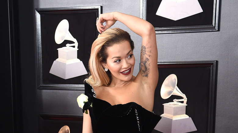 Rita Ora showing arm tattoo