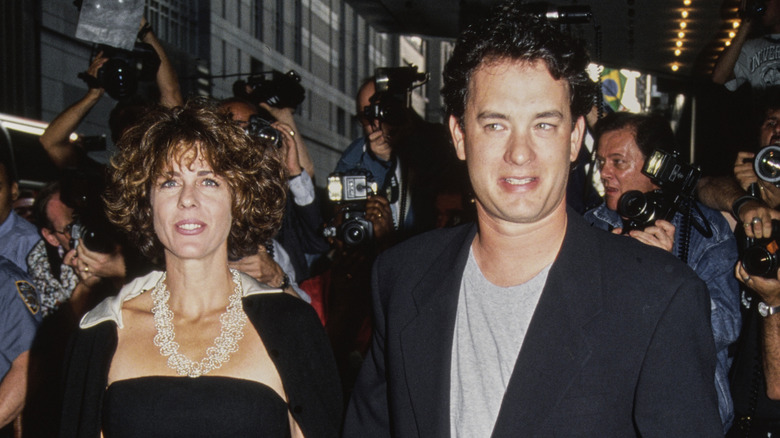 Rita Wilson and Tom Hanks surrounded by a throng of photographers in June 1992