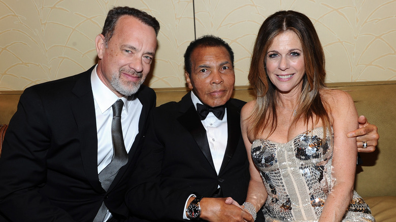 Tom Hanks, Rita Wilson, and Muhammad Ali posing together in 2012