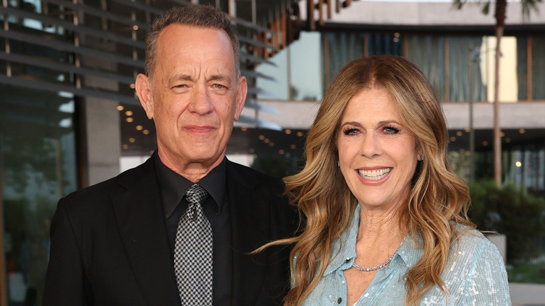 Tom Hanks and Rita Wilson smiling while posing together at an event